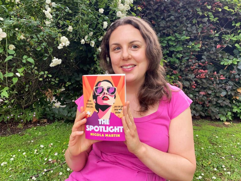 Nicola Martin holding a copy of The Spotlight